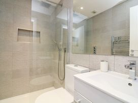 A bathroom with a shower, toilet and sink at 1 The Old Coach House in Dartmouth