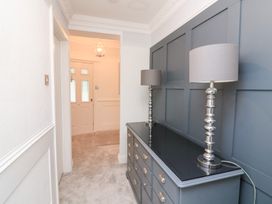 A hallway with a dresser and lamps at 1 The Old Coach House Dartmouth