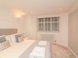 A bedroom with a bed and radiator at 1 The Old Coach House in Dartmouth
