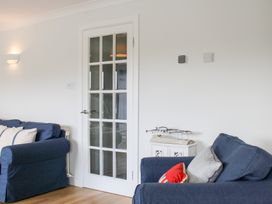 A living room with a door and sofas at 2 Poundstone Court in Salcombe