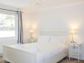 A bedroom with a bed and nightstand at 2 Poundstone Court Salcombe