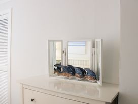A mirror and decorative fish on a dresser at 2 Poundstone Court Salcombe