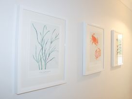 Framed artworks of seaweed and crabs on the wall at 2 Poundstone Court Salcombe