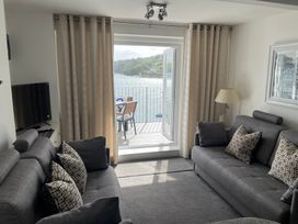 A living room with a view of water in 35 The Salcombe, Salcombe
