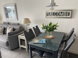 A dining area with a table and chairs at 35 The Salcombe, Salcombe