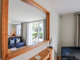 A living room with a sofa and television at 3 Combehaven Salcombe