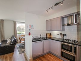 A kitchen featuring stove and sink at 3 Combehaven in Salcombe
