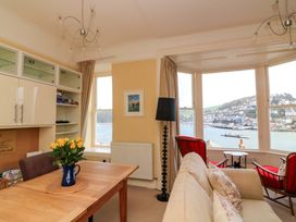 A living room with a dining table and flowers at 3 Dartview in Dartmouth