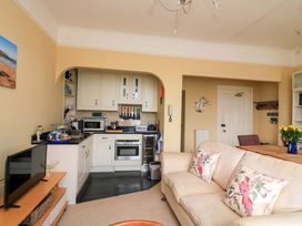 A living room with kitchen appliances and a sofa at 3 Dartview in Dartmouth