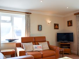 A living room with a sofa and television at 3 Thurlestone Rock in Thurlestone