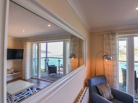 A living room with a TV and sofa at 4 Bolt Head in Salcombe