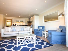 A living room with a sofa and armchairs at 4 Bolt Head in Salcombe