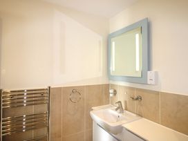 A bathroom with a sink and mirror at 4 Bolt Head in Salcombe