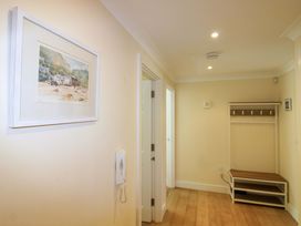 A hallway with a coat rack and a telephone at 4 Bolt Head in Salcombe