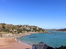 A beach with water and houses at 4 Bolt Head in Salcombe