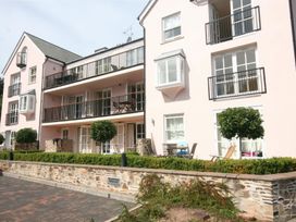 A building with balconies and planters at 6 Combehaven Salcombe