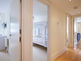 A hallway with a bunk bed and television at 6 Combehaven in Salcombe
