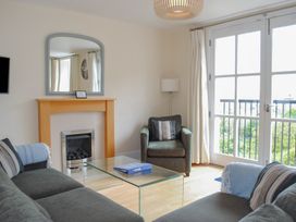 A living room with a sofa and coffee table at 6 Combehaven, Salcombe