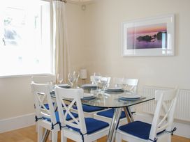 A dining room with a glass table and chairs at 6 Combehaven Salcombe