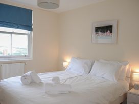 A bedroom with a bed and window at 6 Combehaven, Salcombe