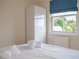 A bedroom with a bed and towels on it at 6 Combehaven in Salcombe