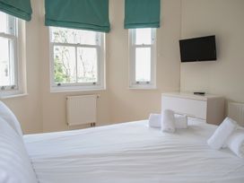 A bedroom with a bed and towels on it at 6 Combehaven Salcombe