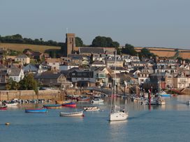 A view of boats near a harbor with houses and a church in Salcombe