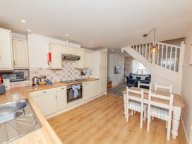 A kitchen with dining area and stairs at 7 Charles Street Dartmouth