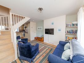 A living room with a television and bookshelves at 7 Charles Street Dartmouth