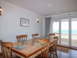 A dining room with a table and chairs at 7 Thurlestone Rock in Thurlestone