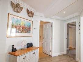 A hallway with a painting and a cabinet at 7 Thurlestone Rock in Thurlestone