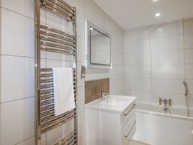 A bathroom with a sink and bathtub at 7 Thurlestone Rock in Thurlestone