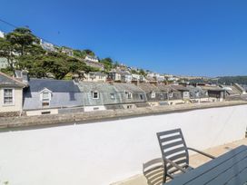 A view of houses and trees from a patio at Armada Cottage Dartmouth