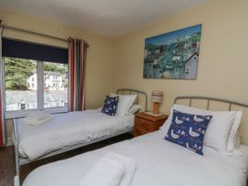 A bedroom with two beds and a nightstand at Armada Cottage Dartmouth