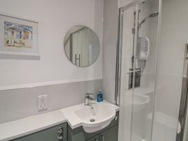 A bathroom with a sink and shower at Armada Cottage Dartmouth