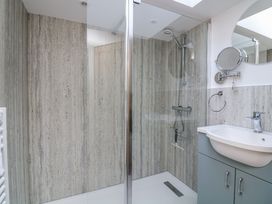 A bathroom with a shower and sink at Armada Cottage Dartmouth