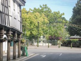 A street view with a historic building and entrance to Royal Avenue Gardens in Dartmouth