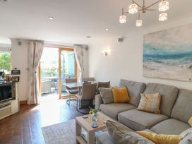 A living room with a sofa and a dining table at 6 Court Cottage, Hillfield Village Dartmouth