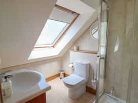 A bathroom with a shower and toilet at 6 Court Cottage, Hillfield Village Dartmouth