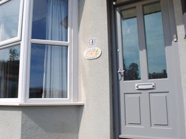 An entrance with a door and a window at Crab Cottage in Salcombe