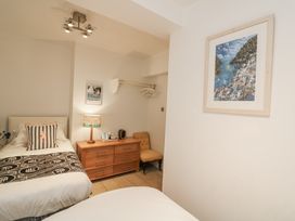 A bedroom with two beds and a nightstand at Dart Views in Dartmouth