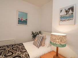 A bedroom with a bed and wall art at Dart Views in Dartmouth