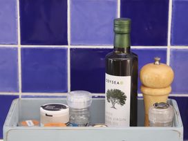 A kitchen counter with olive oil and spices at Dart Views in Dartmouth