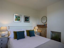 A bedroom with a bed and nightstand at Dart Views in Dartmouth