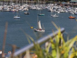 A sailing boat on the water among yachts at Dart Views in Dartmouth