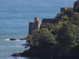 A castle near the ocean with trees and boats at Dart Views in Dartmouth