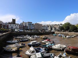 A view of boats in the harbor with buildings in Dartmouth