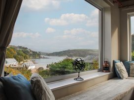 A sitting room with a window view at Dolphins in Salcombe