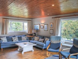 A living room with a sofa and coffee table at Dolphins in Salcombe