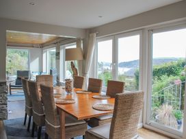 A dining room with a large table and chairs at Dolphins in Salcombe